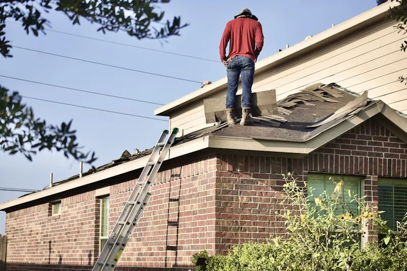 Professional roofer working on a residential roof in Port Lavaca